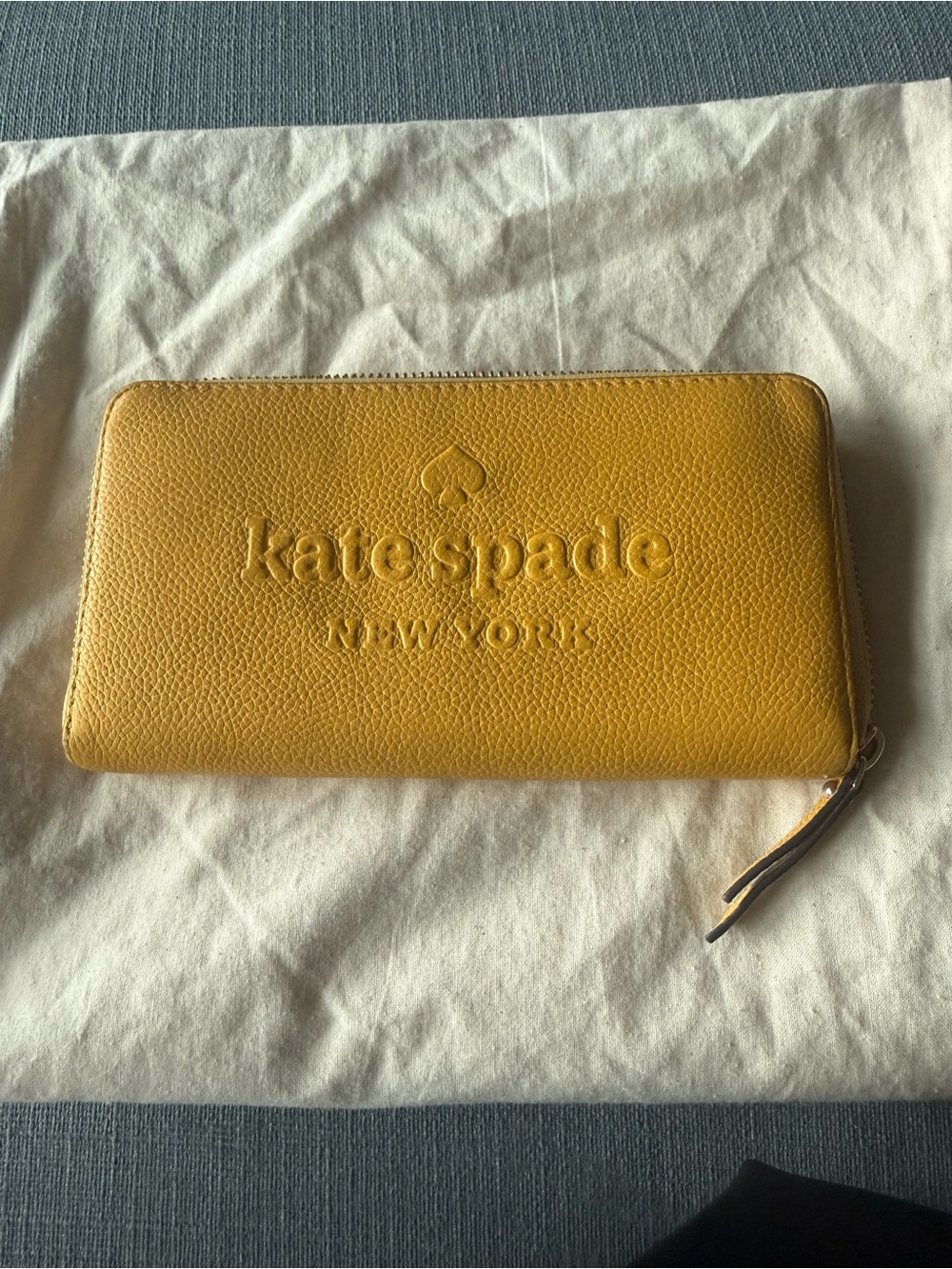 kate spade New York yellow zip-around pebbled leather wallet